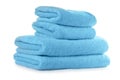 Stacked clean turquoise towels on white