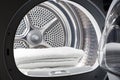 Stacked clean white towels inside washing machine drum. Clean concept. Laundry. Closeup of open washing machine Royalty Free Stock Photo