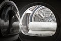 Stacked clean white towels inside washing machine drum. Clean concept. Laundry. Closeup of open washing machine Royalty Free Stock Photo