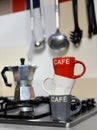 Stacked coffee cup and vintage coffeepot on kitchen stove