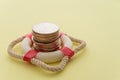 Stacked coins in red lifebuoy or lifebelt with yellow background copy space. Assets wealth, money saving or money investment