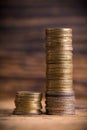 Stacked coins showing income difference proportion between rich and normal incomes