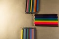 Stacked colored pencils. Isolated on brown background Royalty Free Stock Photo