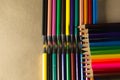 Stacked colored pencils. Isolated on brown background Royalty Free Stock Photo