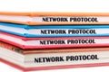 Stacked colorful binders labeled network protocol focus on technology concepts, emphasizing the importance of networking in modern Royalty Free Stock Photo