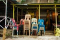 Stacked colorful chairs of a closed island bar