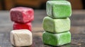 Stacked Colorful Cube Shaped Candies on Wooden Surface