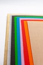 stacked corrugated cardboard papers of various colors