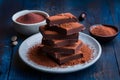 Stacked dark chocolate pieces paired with rich cocoa powder, decadent delight