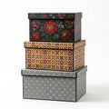 Stacked decorative boxes with floral and geometric patterns in a vertical arrangement Royalty Free Stock Photo