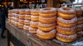 Stacked donuts, sugared and golden, on a rustic wooden counter Royalty Free Stock Photo