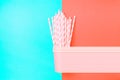 Stacked Drinking Paper Cups With Striped Straws On Duo Tone Mint Blue Crimson Background. Flat Lay. Birthday Party Celebration