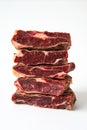 Stacked Dry-Aged Beef Steaks on White Background Royalty Free Stock Photo