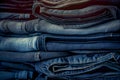 Stacked fashion jeans closeup. Folded blue jean trousers which are stacked