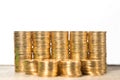 Stacked gold coins on white background