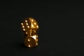 Stacked gold dices on black background