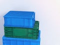 Stacked Green and Blue Plastic Baskets Against White Wall Royalty Free Stock Photo