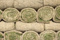 The stacked green lawn rolls