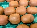 Stacked group of kiwifruits, kiwi or Chinese gooseberry, which is an edible berry from Actinidia genus. Detailed hairy texture of