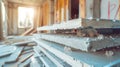 Stacked gypsum plasterboard in a construction setting with natural light