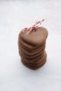 Stacked heart shaped cookies wrapped with red and white twine.