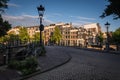 Amsterdam cityscape at sunset with typical dutch houses in the background, the Netherlands. Royalty Free Stock Photo