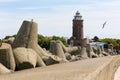 Stacked huge concrete blocks and lighthouse