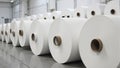 Stacked industrial paper rolls in a bright clean paper mill Royalty Free Stock Photo