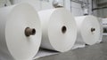 Stacked industrial paper rolls in a bright clean paper mill Royalty Free Stock Photo