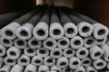 Stacked insulation for pipes of polyethylene foam in warehouse Royalty Free Stock Photo