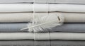 Stacked linens in various shades of white, beige, and gray create a gradie Royalty Free Stock Photo