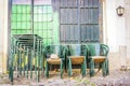 Stacked green tables and chairs on Lisbon street, Portugal