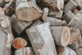 Stacked logs of firewood, natural wooden background. Hardwood fuel, harvesting chopped wood for the winter.