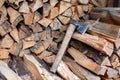 The stacked lumber lies in the woodpile. Axe with wooden handle Royalty Free Stock Photo