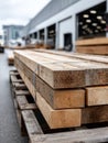 Stacked lumber planks outside a warehouse, ready for use. Royalty Free Stock Photo