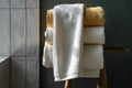 Stacked luxury bath towels on wooden stool