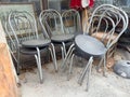 Stacked metal chairs in outdoor setting with concrete floor Royalty Free Stock Photo