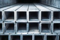 Stacked metallic rectangular hollow tubes arranged neatly showcasing industrial construction material with detailed textures and Royalty Free Stock Photo
