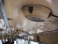 Stacked monkey bar and old speaker attached on ceiling in Thai public bus