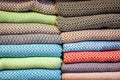 Stacked multicolored clothing fabric in the closet bed linen banner. Royalty Free Stock Photo