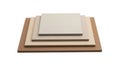 Stacked neutral-colored flat panels on a wooden base for interior design or display Royalty Free Stock Photo