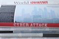 Stacked newspapers with headline CYBER ATTACK as background, closeup