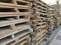 Stacked old used wooden pallets on street. Stacks of Euro-type cargo pallets Royalty Free Stock Photo