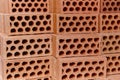 Stacked orange bricks detail. Construction industry. Masonry