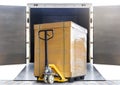 Stacked package box on plastic pallet rack loading into shipping container. Cargo shipment boxes, Road freight truck. Warehousing. Royalty Free Stock Photo