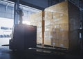 Stacked of Package Boxes with Electric Forklift Pallet Jack at The Storage Warehouse. Shipping Warehouse Logistics Royalty Free Stock Photo