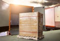 Stacked of Package Boxes on Pallet Load with Cargo Container. Trucks Parked Loading at Dock Warehouse. Delivery Service. Logistics Royalty Free Stock Photo