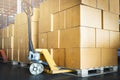 Stacked of Package Boxes on Wooden Pallet and Hand Pallet Truck at Storage Warehouse. Shipment Boxes. Cargo Export- Import. Royalty Free Stock Photo