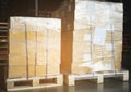 Stacked of Package Boxes Wrapped Plastic Film on Pallet at Storage Warehouse. Shipment Boxes. Cargo Export- Import. Royalty Free Stock Photo