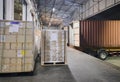 Stacked of package boxes wrapping plastic on pallet waiting to load into shipping container. Cargo shipment boxes, Freight truck.